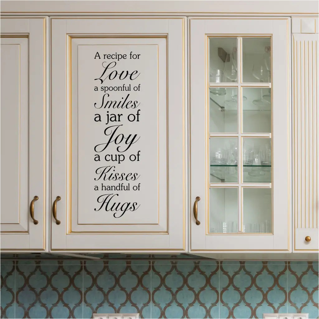 "Recipe for Love" wall decal displayed vertically on a kitchen cabinet door.