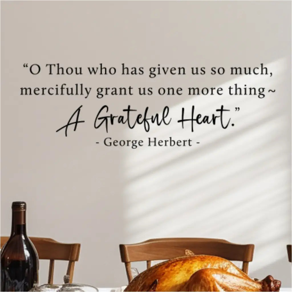 The "A Grateful Heart" prayer decal on a wall behind a dining table set with a roasted Thanksgiving turkey.