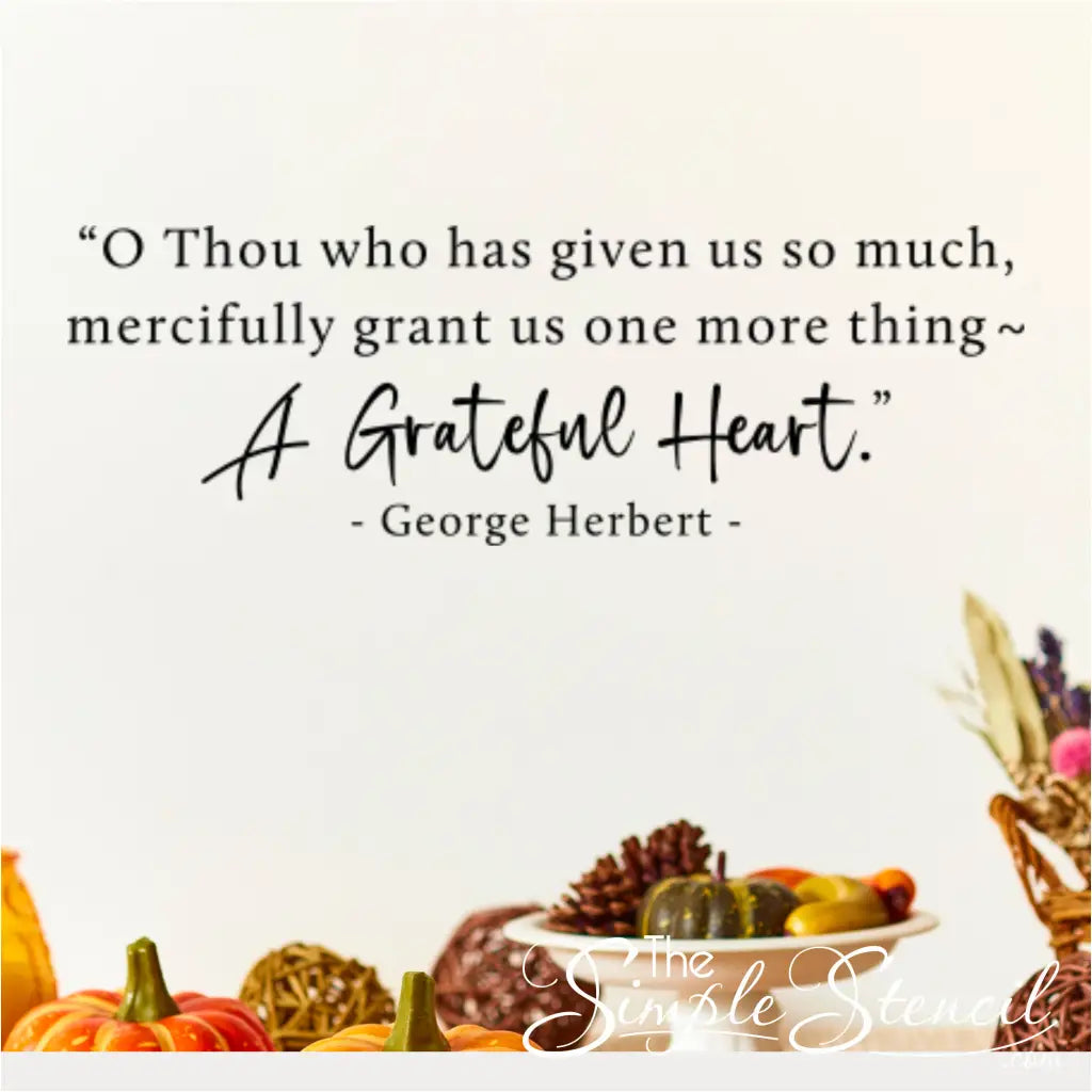 The "A Grateful Heart" Thanksgiving prayer decal shown on a wall above a fall display of pumpkins, gourds, and pinecones.