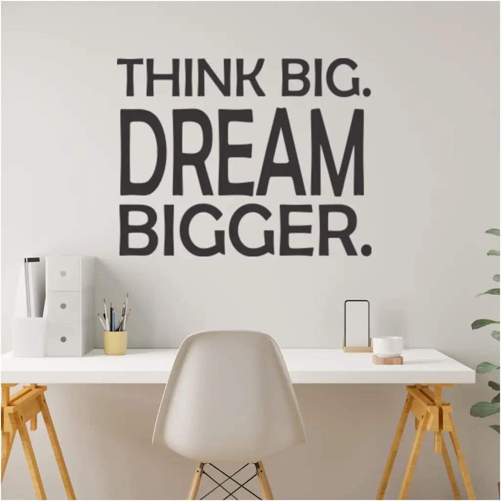  A sleek black "Think Big. Dream Bigger." wall decal adds a powerful motivational touch to a modern office space, urging employees to reach for their full potential. By The Simple Stencil