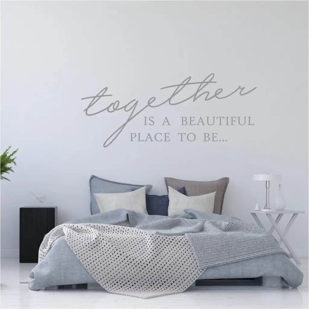 Master bedroom with beautiful decor including a wall quote decal over the bed that reads: Together is a beautiful place to be...