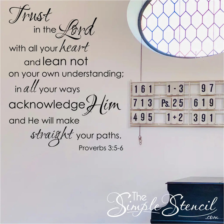 The bible verse wall sticker by The Simple Stencil shown on a church wall near the hymnal display that reads: Trust in the Lord with all thine heart and lean not on your own understanding; in all your ways acknowledge Him and He will make straight your paths. Proverbs 3:5-6