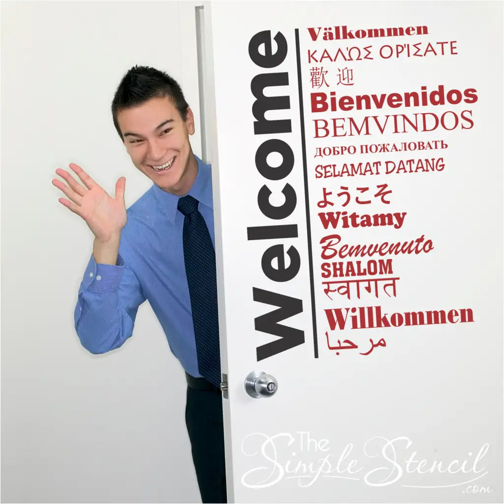 Welcome wall decals translated into 15 different languages displayed on an entry door.