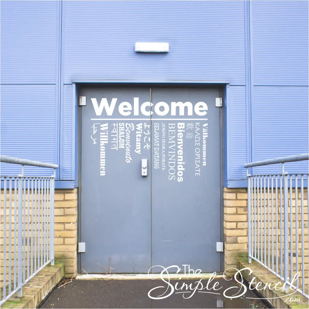Large Welcome in 15 languages decals installed on two entry doors leading to a gym at a school that frequently hosts foreign students.