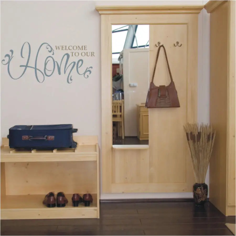 Welcome to our Home - A two color vinyl wall decal by The Simple Stencil placed on an entryway or foyer wall in two beautiful matte finish colors to match the natural decor.