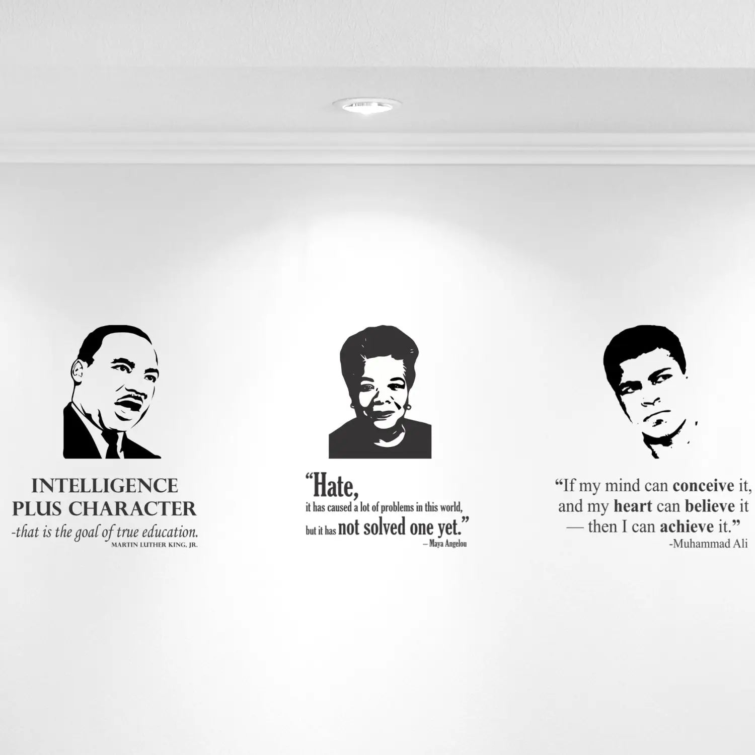 Black History Month vinyl decals for schools displayed on a hallway wall. Black leader face silhouettes next to some of their most inspiring quotes. By TheSimpleStencil