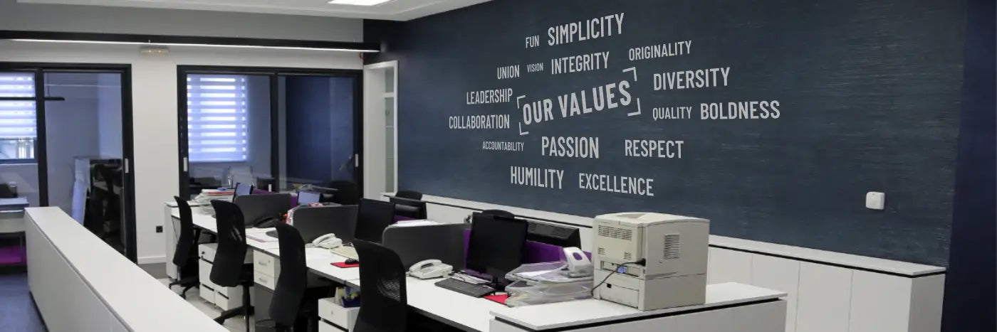 Modern office with motivational wall decals featuring inspiring quotes.