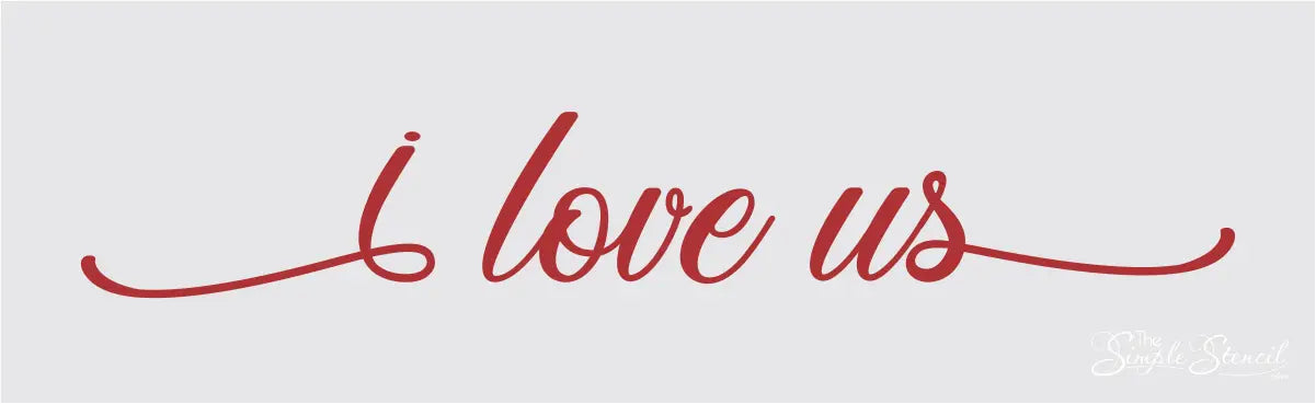 Red "I love us" vinyl wall decal displayed in a cozy living room, featured in The Simple Stencil red wall decals collection.