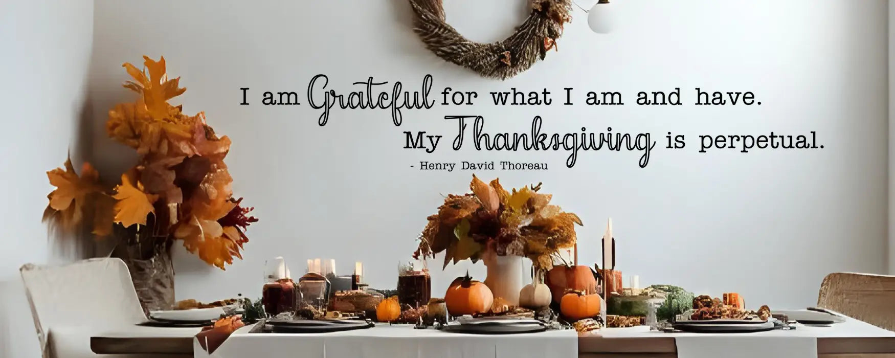 Inspirational Thanksgiving wall decal featuring a Henry David Thoreau quote on gratitude, shown above a beautifully decorated rustic dining table.