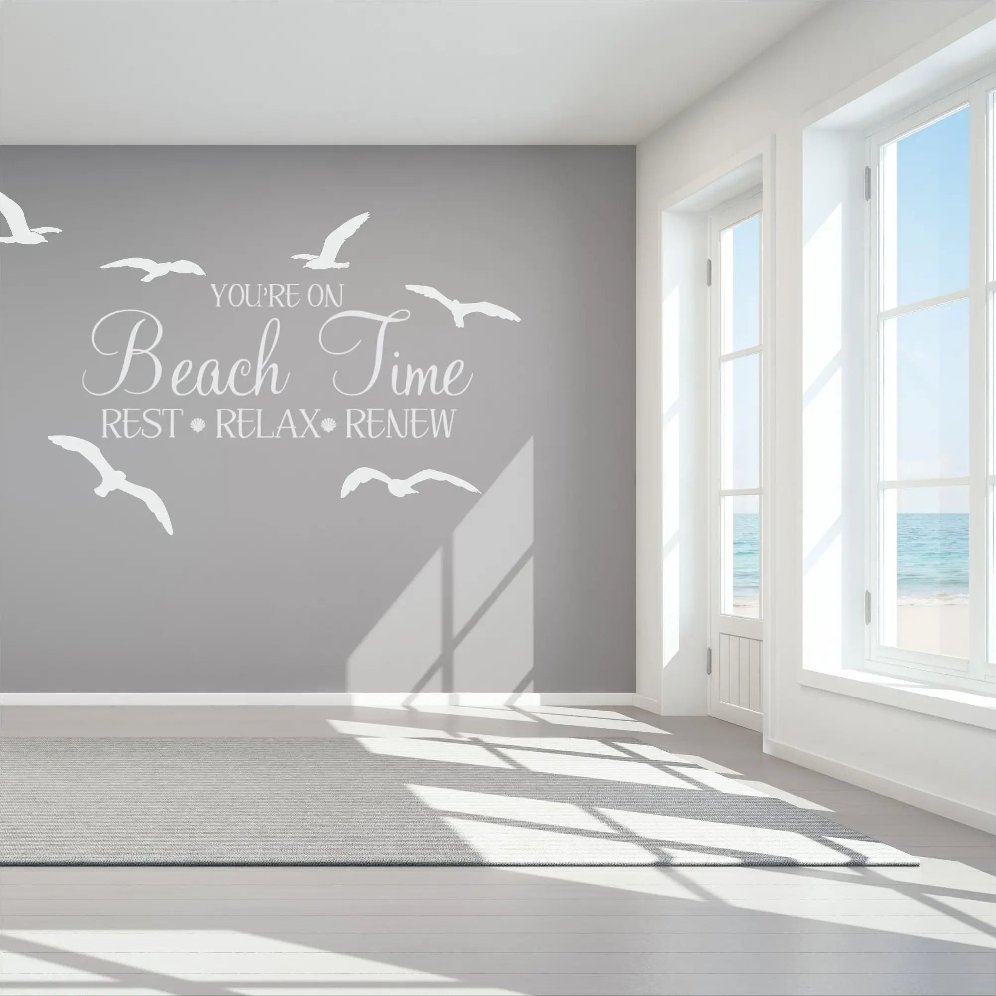 Crisp white vinyl wall decal quote and seagull set displayed on a grey beach house bedroom wall, featured in The Simple Stencil white wall decals collection.