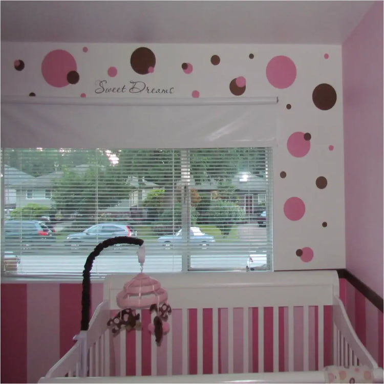 Pink and Brown polka dot themed baby nursery using easy Peel and Stick vinyl wall decals by The Simple Stencil transformed this baby nursery in minutes!