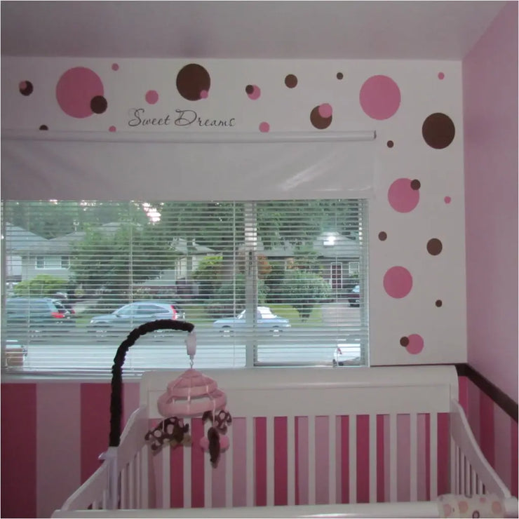 Pink and Brown polka dot themed baby nursery using easy Peel and Stick vinyl wall decals by The Simple Stencil transformed this baby nursery in minutes!
