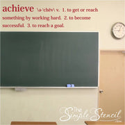 A large Achieve definition decal wall art placed on a classroom wall over a chalkboard where students can read it often.