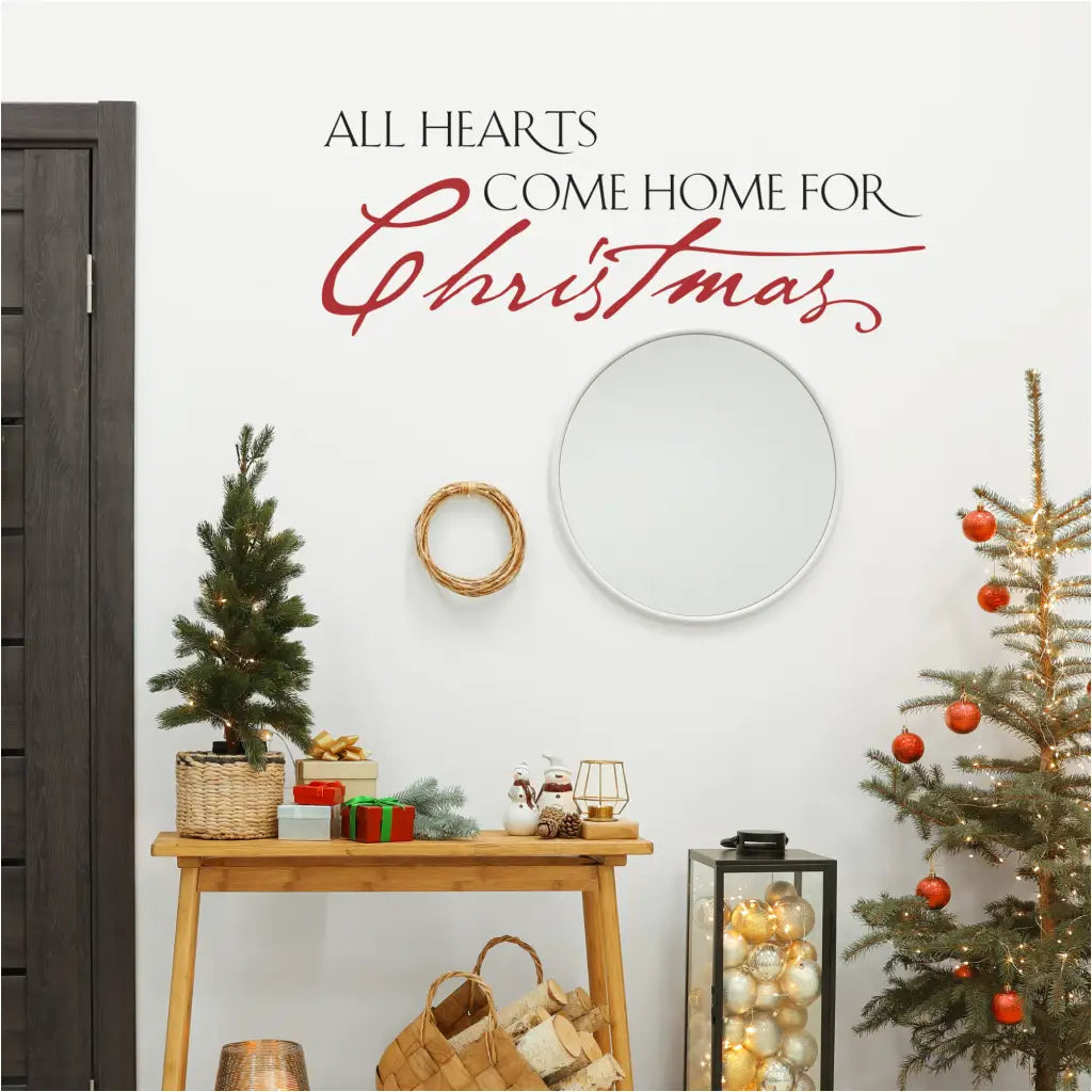 Vinyl wall decal with the phrase "All hearts come home for Christmas" in a festive script font.