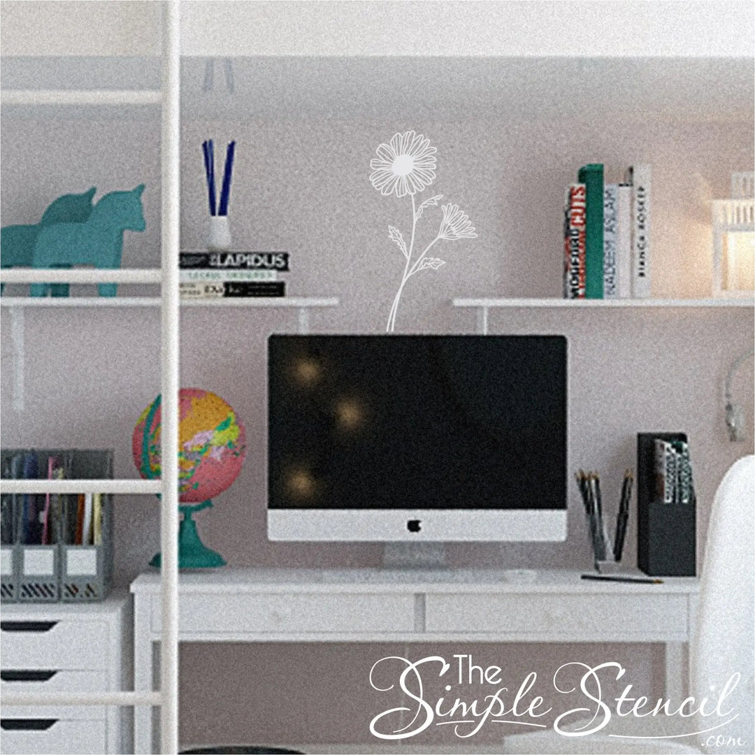 White Daisy botanical wall lettering centered above a minimalist white desk in a bright, intentional home office or study space.