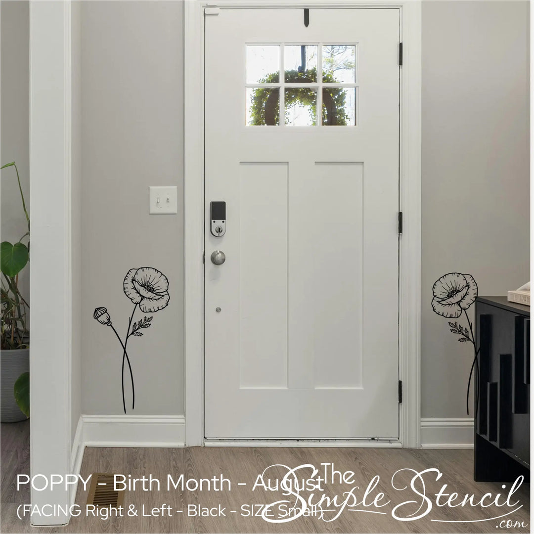 Two small black Poppy wall accents framing a white front door in a minimalist, welcoming entryway.