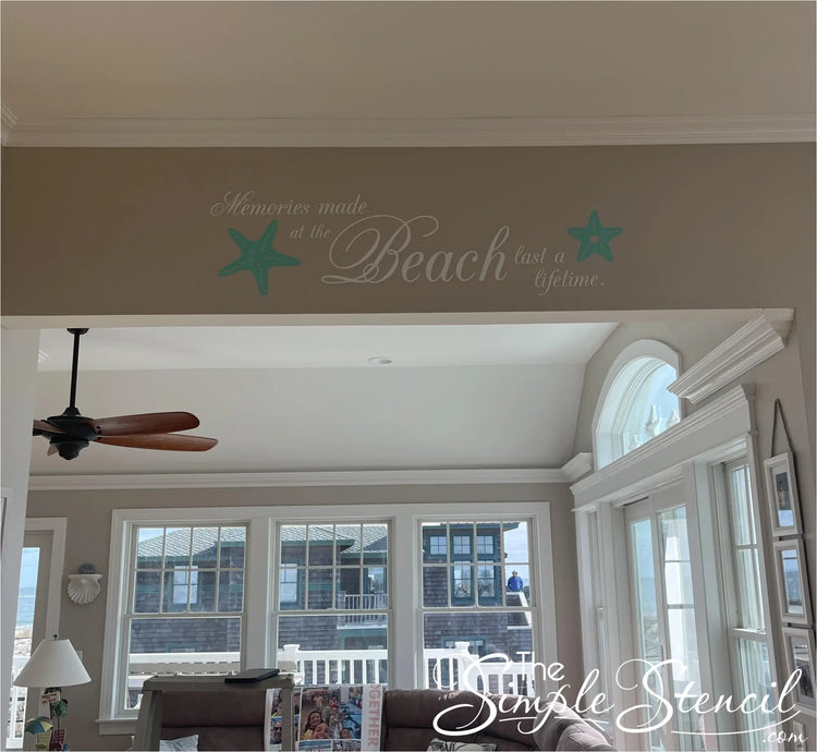 A charming wall decal adorns the sun-drenched interior of a beachfront home, its message "Memories made at the beach last a lifetime" resonating with the picturesque ocean view beyond. Two playful starfish graphics, their delicate forms reminiscent of seaside treasures, complement the heartfelt sentiment, capturing the essence of enduring coastal memories.