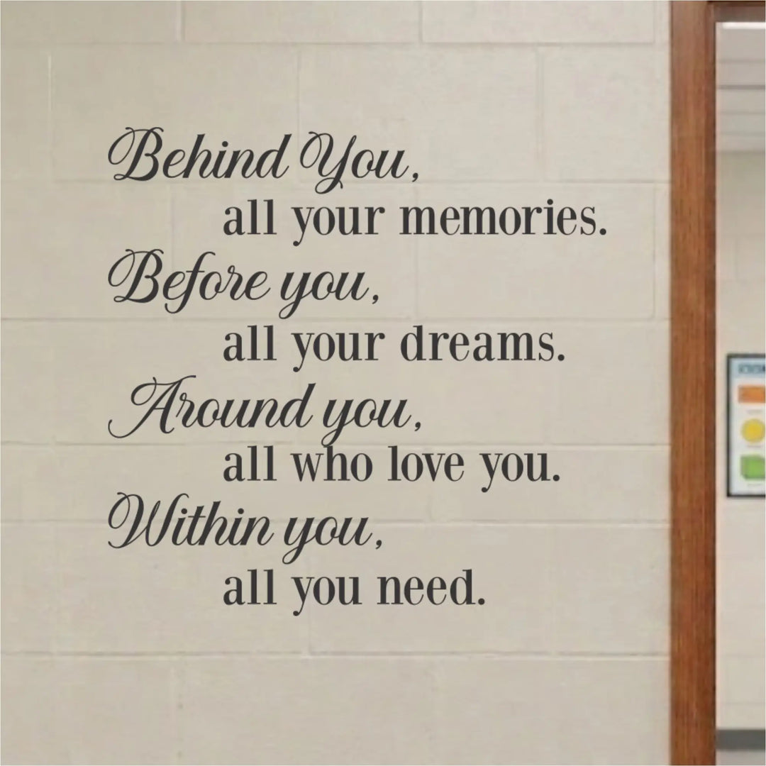 Black vinyl wall decal featuring a motivational quote, displayed on a light beige brick wall next to a wooden door frame.