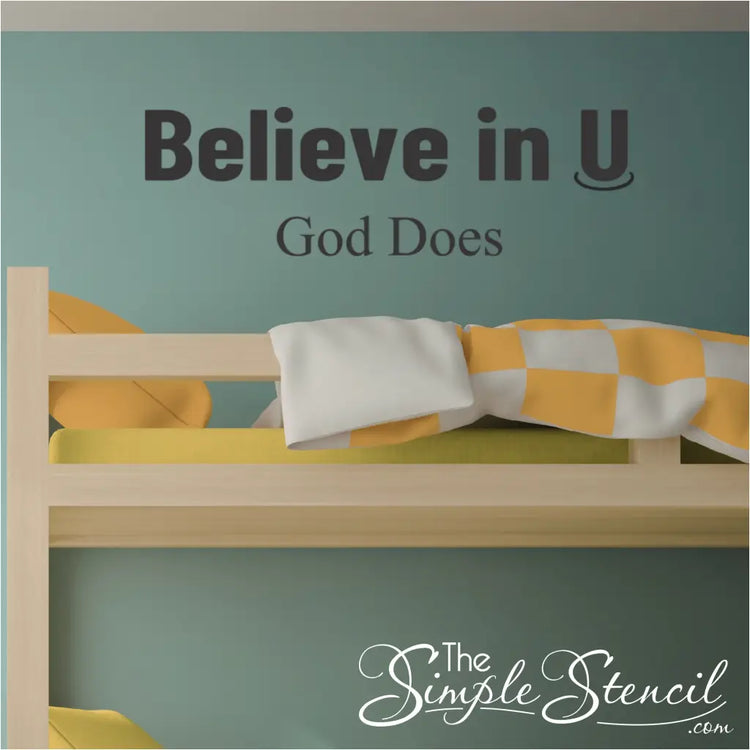 Believe in U God Does" vinyl wall decal applied above a teen's bed in a bedroom, featuring modern typography for Christian home decor.