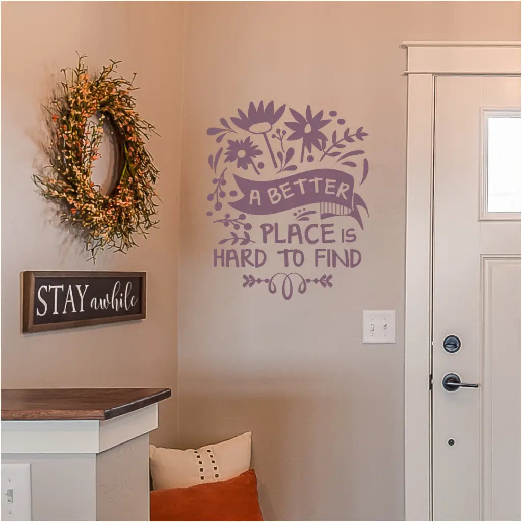 A vinyl wall decal that reads: A better place is hard to find and is surrounded by flowers and embellishments to decorate your favorite room or sitting area. By The Simple Stencil