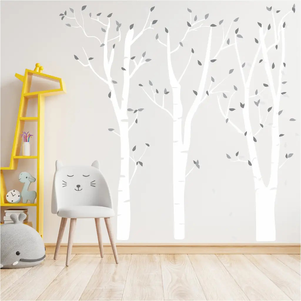 set of birch tree wall decals with branches and leaves in multiple colors to create your own tree wall to match your home, classroom, etc. Shown in white with shades of grey for the leaves. 