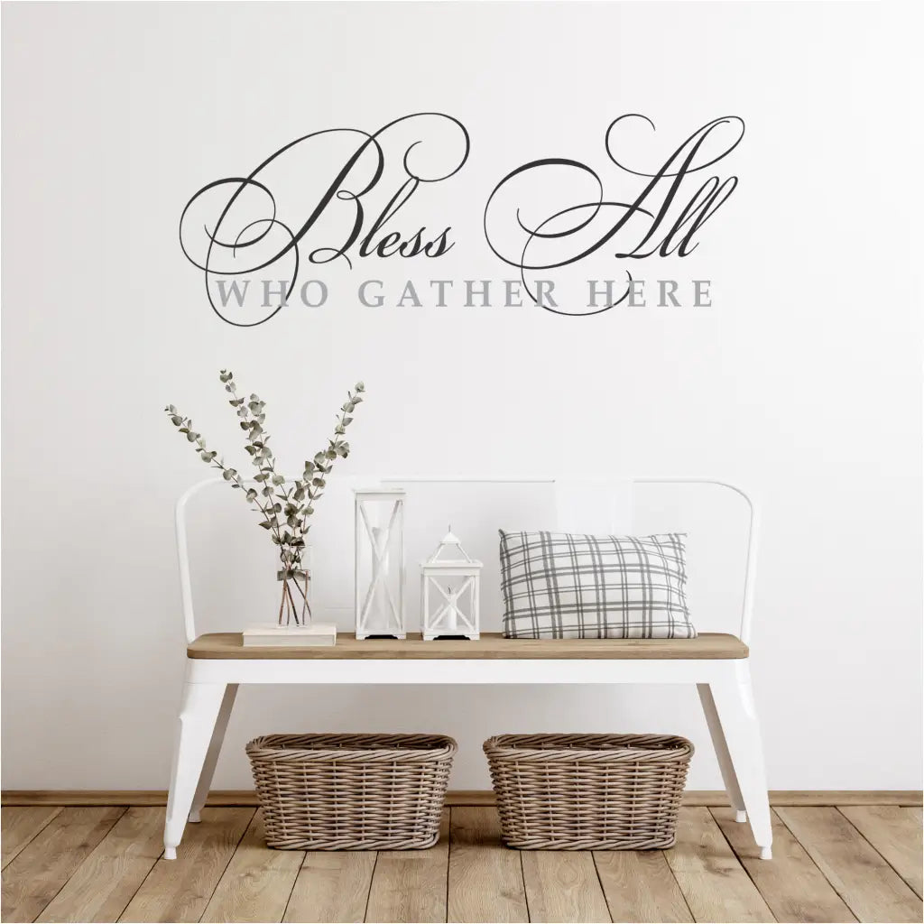 "Bless All Who Gather Here" vinyl wall decal, featuring a delicate flourish design, adds a touch of elegance and charm to any gathering space.