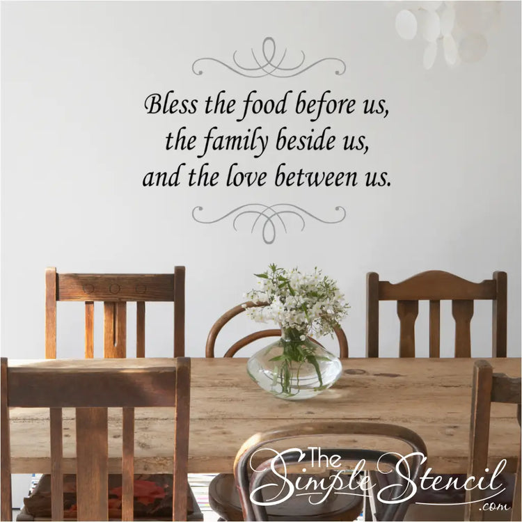Thanksgiving Wall Decal Over Rustic Farmhouse Table - A beautiful Bless the Food Before Us wall decal installed over a rustic farmhouse table, creating a warm and inviting atmosphere for your Thanksgiving gathering.