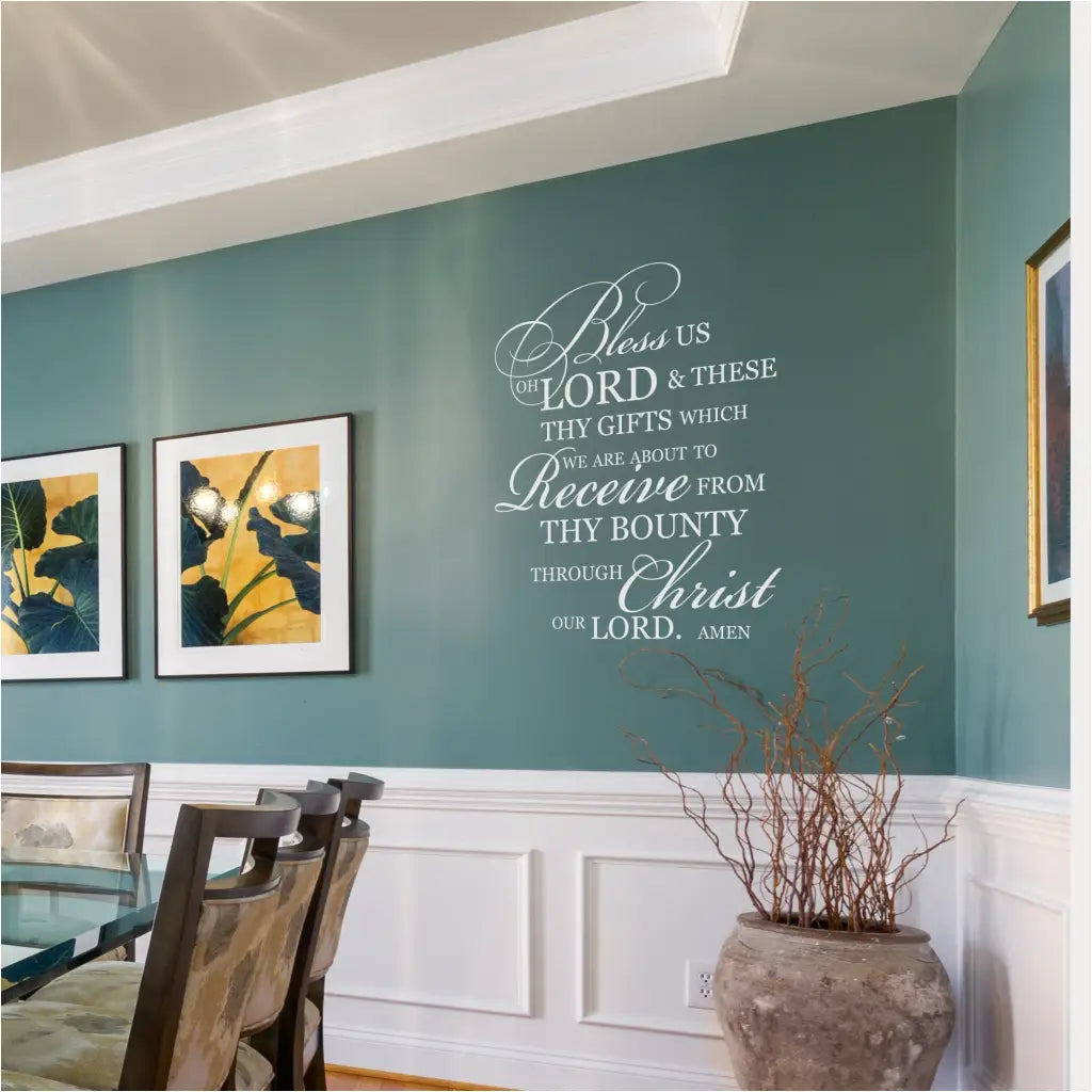 "Bless Us Oh Lord" wall decal in white vinyl on a dark blue green dining room wall.