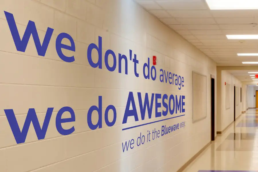 Blue wall decal with bold text reading ’we don’t do average.