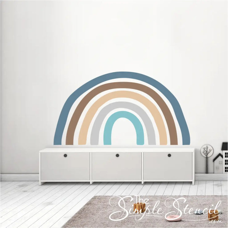 Natural hues rainbow wall decal display shown as a mural on a large playroom wall. The natural hues are perfect for a boys room or a mountain or other nature themed room. Contact The Simple Stencil for custom sizes and color schemes. 