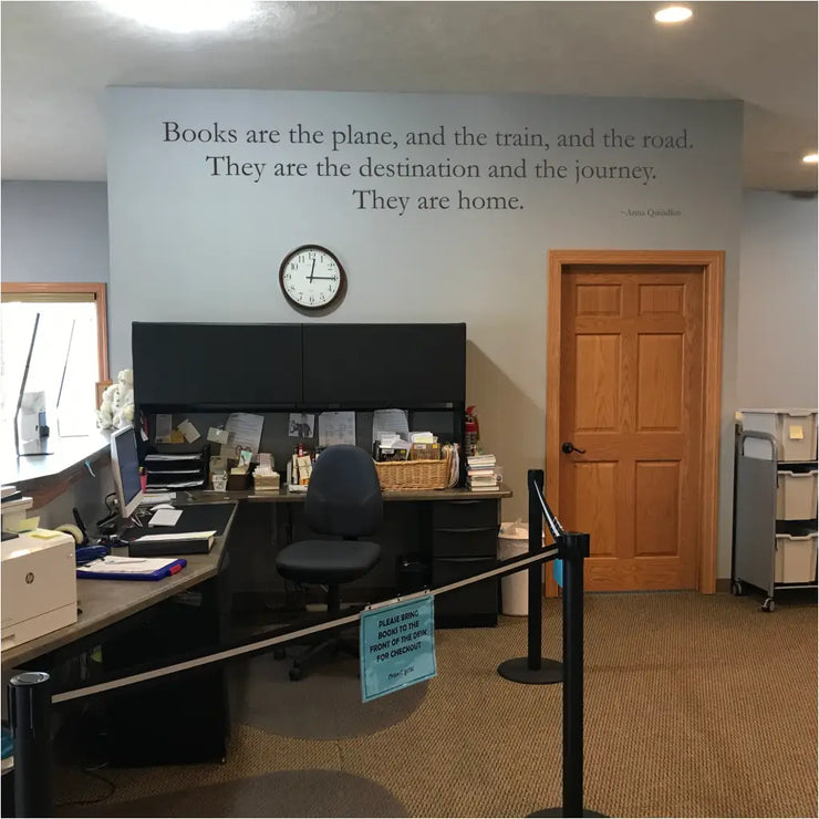 Imagine this decal in your spacious library with floor-to-ceiling bookshelves brimming with books. Natural light streams through a large window, illuminating a welcoming atmosphere. On the wall, a captivating vinyl decal featuring Anna Quindlen&