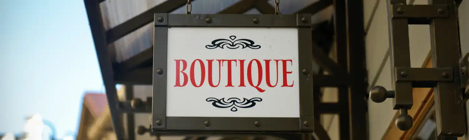 Boutique sign with decorative flourishes.