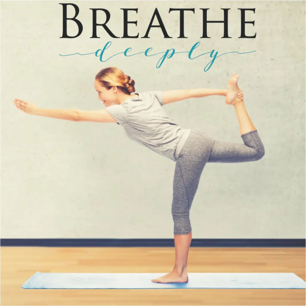 A girl in a yoga pose standing in front of a large wall decal that reads Breathe Deeply by The Simple Stencil