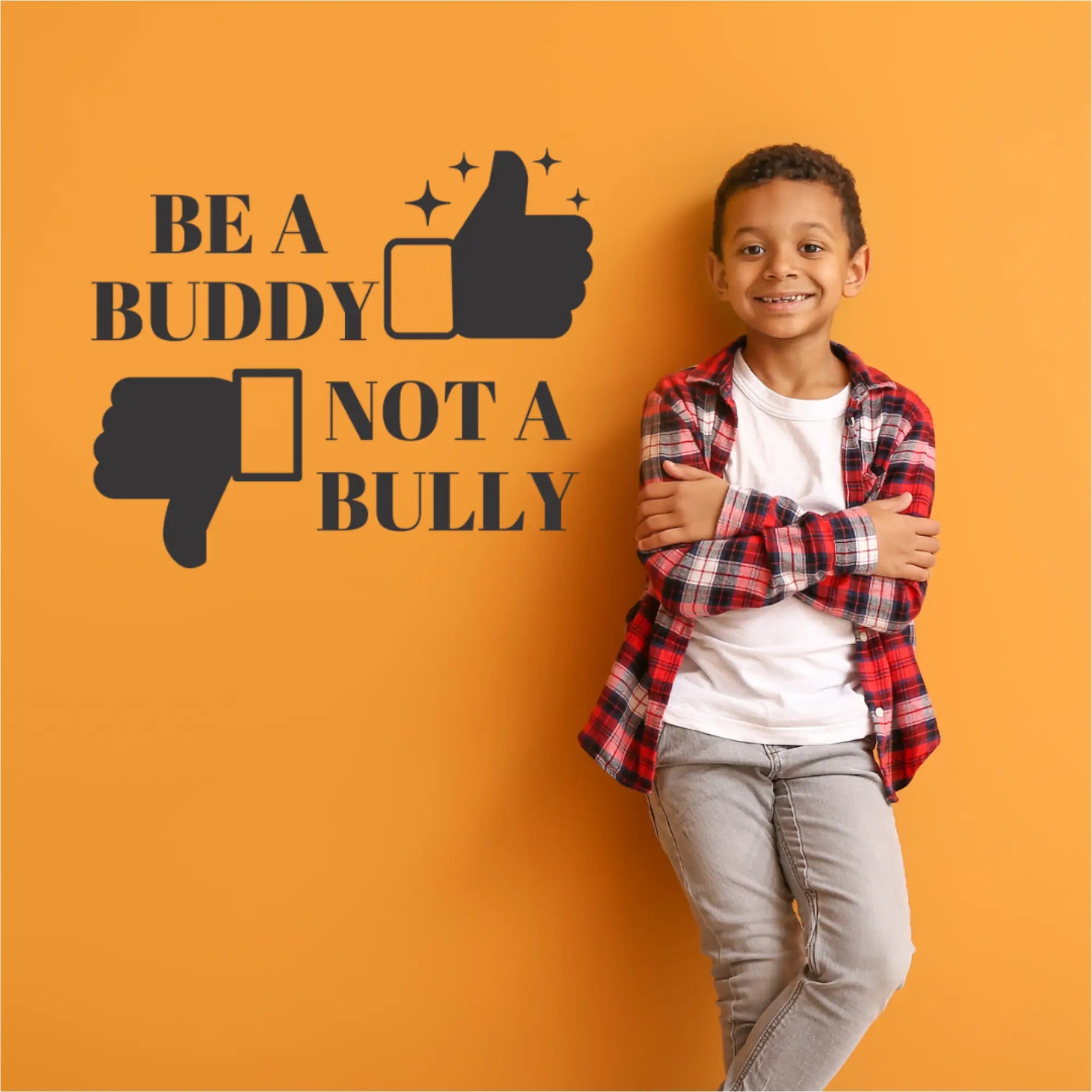 Be A Buddy Not A Bully - Vinyl Wall Decal for School Decor to promote Kindness in your school classrooms and learning environments. Features a thumbs up and down hand to add visual appeal. Shown on a wall next to a student who won the classroom kindness award. By The Simple Stencil