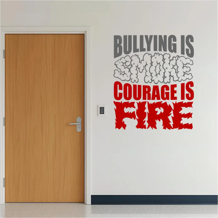 A full view of the "Bullying is Smoke, Courage is Fire" decal shown as a mockup on a light-colored wall in a classroom or school hallway setting. The decal is displayed at eye level, showcasing its size and potential placement.