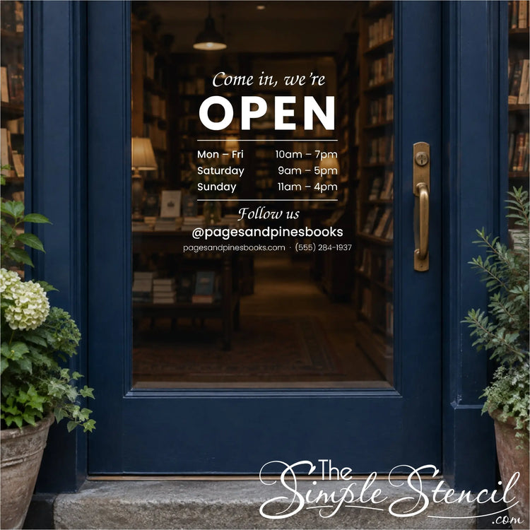 Open sign vinyl decal with store hours and Instagram handle on a bookstore's glass door