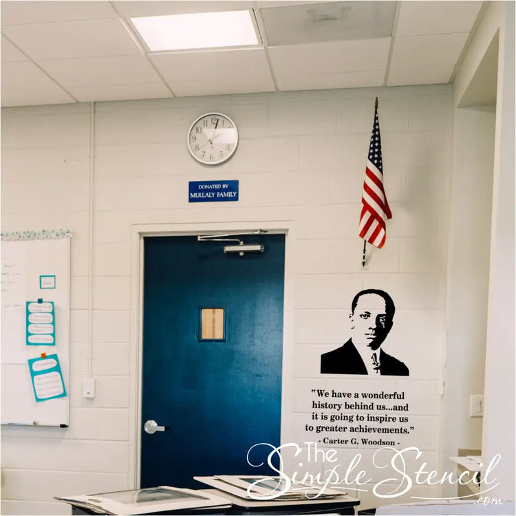 Classroom interior with a blue door, American flag, and motivational quote on the wall by Carter G. Woodson
black history month display below flag. 