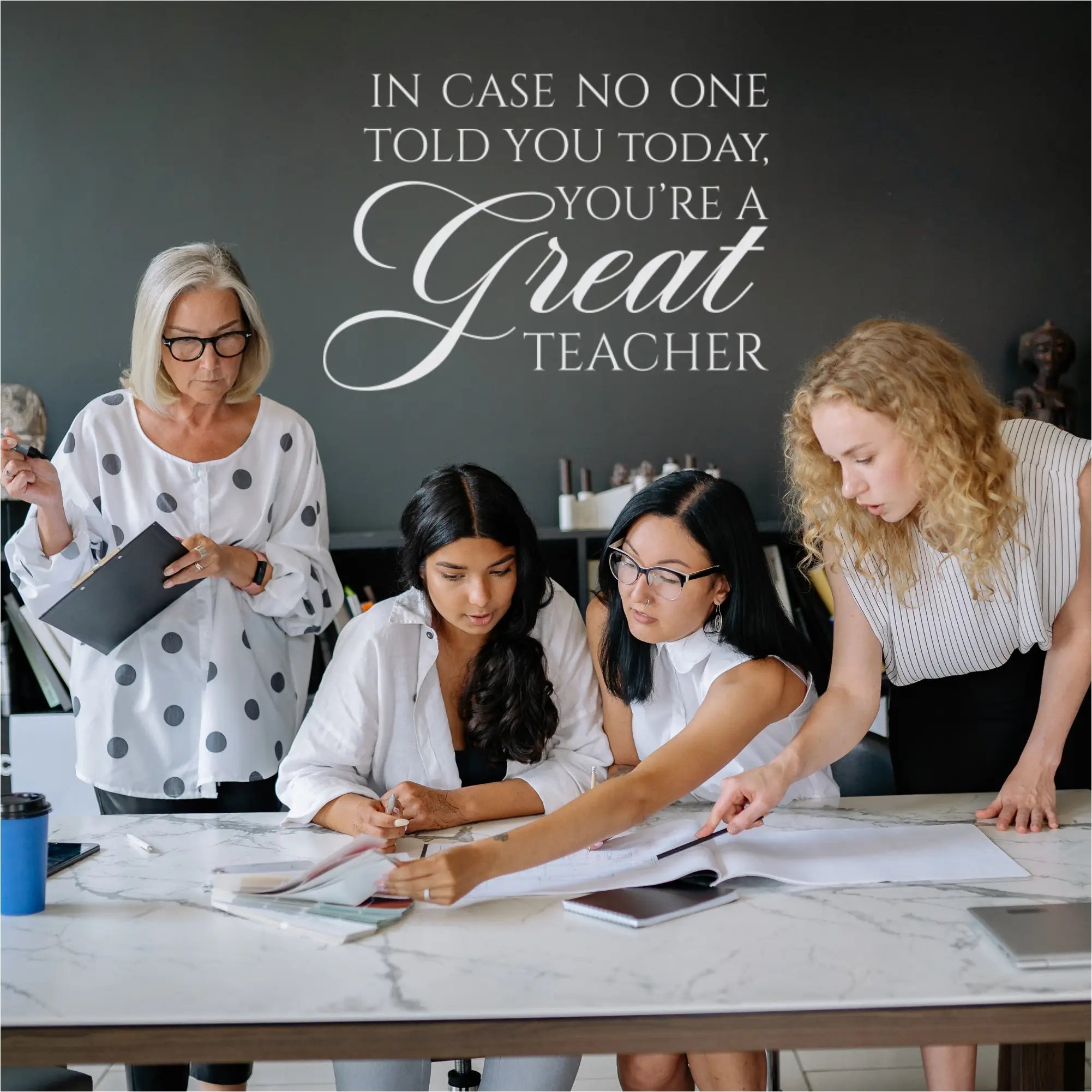 The "In case no one has told you today, you're a GREAT teacher" wall decal displayed in a teacher's lounge.