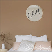 A vinyl decal from The Simple Stencil that reads "Chill" installed on a round mirror over a guest room bed is a great way to encourage relaxation!