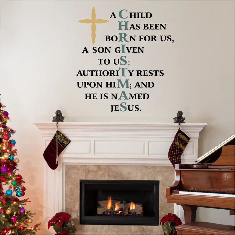 Vinyl wall decal with the verse "A child has been born for us..." and a decorative cross hung on a family room wall for Christmas