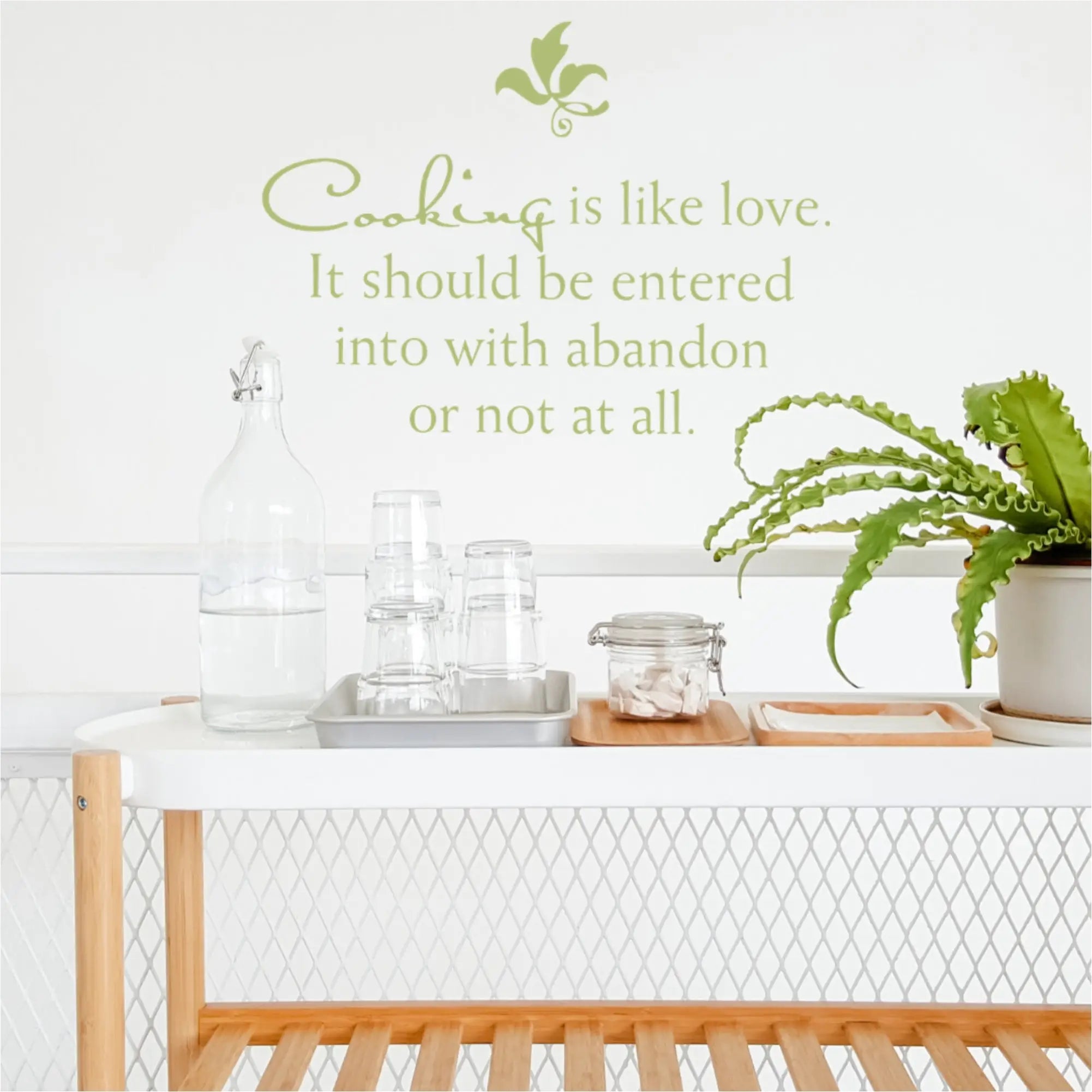 Cute wall quote decal on kitchen wall that reads: Cooking is like love. It should be entered into with abandon or not at all. 