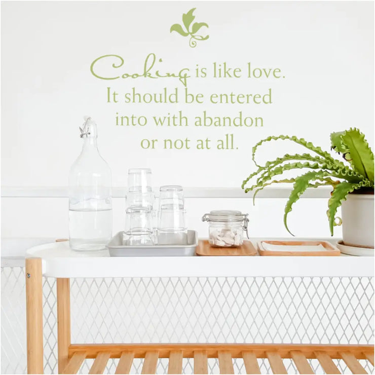Cute wall quote decal on kitchen wall that reads: Cooking is like love. It should be entered into with abandon or not at all. 