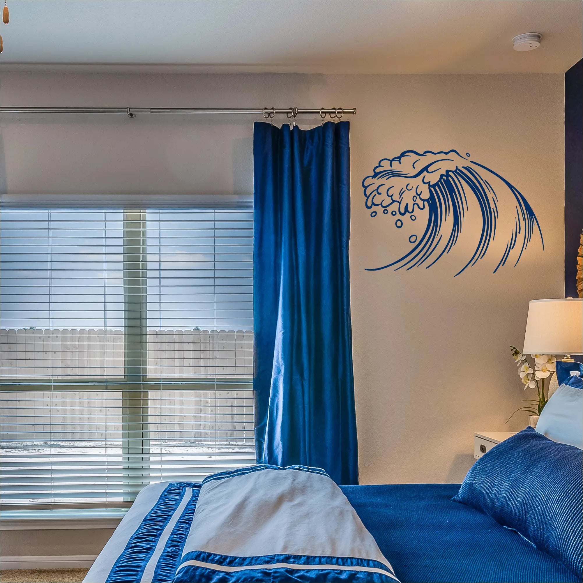 Deep blue velvet curtain next to a matching crashing wave wall decal with a free practice decal option