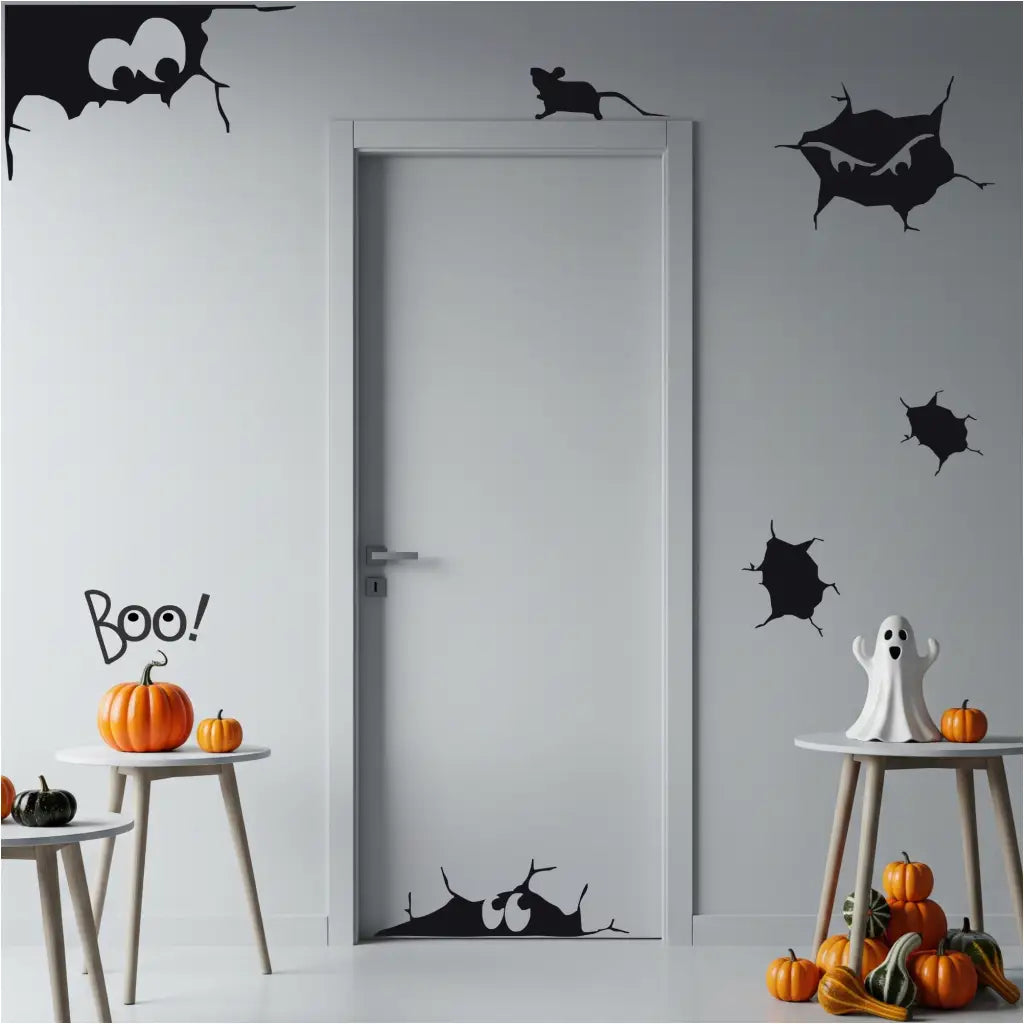 A close-up of a white door and walls decorated for Halloween with black vinyl decals of spooky cracks and a rat. The Simple Stencil decals shown in matte black size Large.