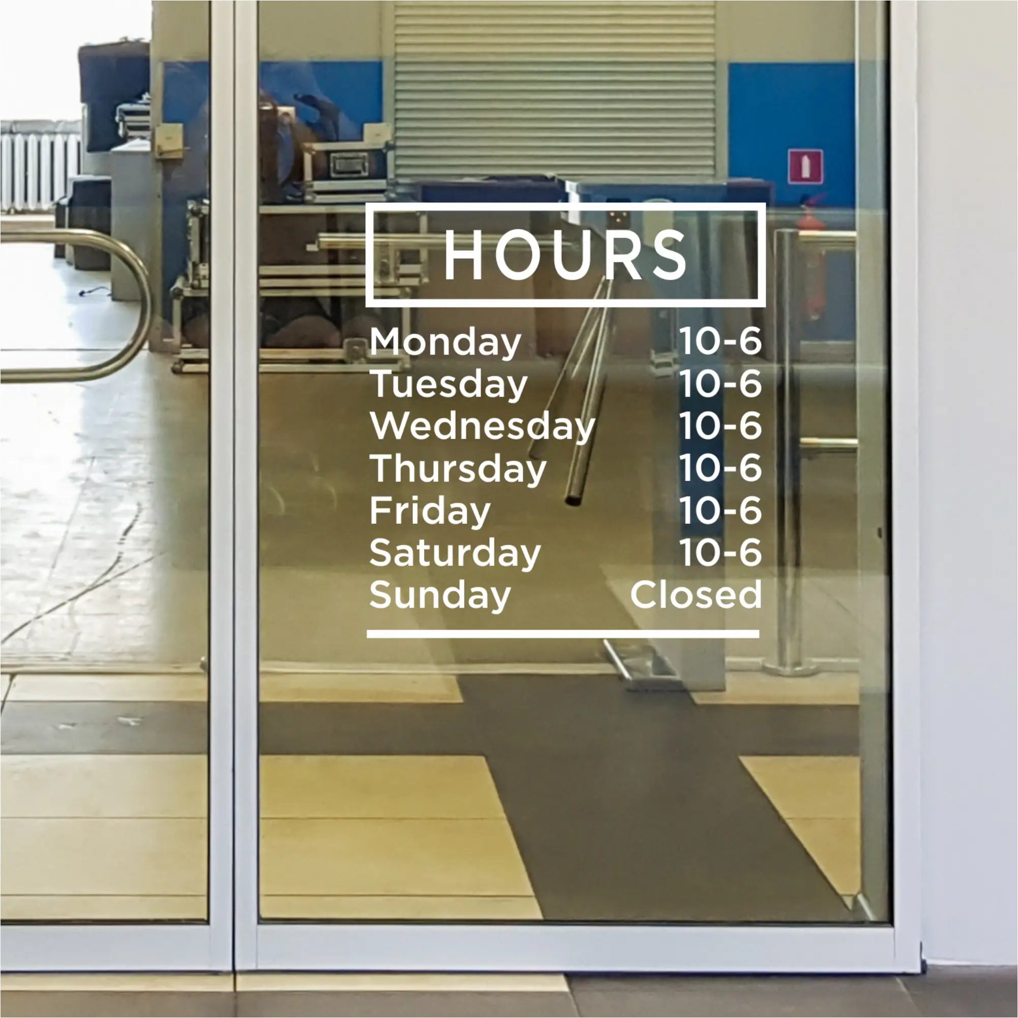 Modern office building with a custom business hours decal displayed on the glass entrance.