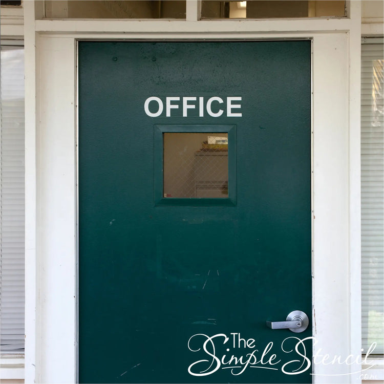 A dark green metal office door with a square window featuring high quality, low cost custom name decals now