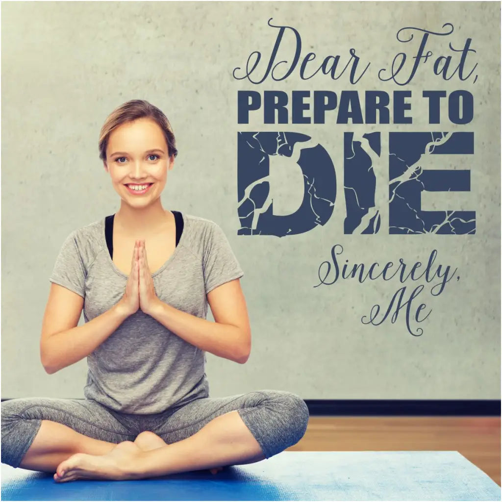 Fitness center wall quote decal displayed on a wall next to a girl doing yoga that reads: Dear Fat, prepare to die. Sincerely, Me