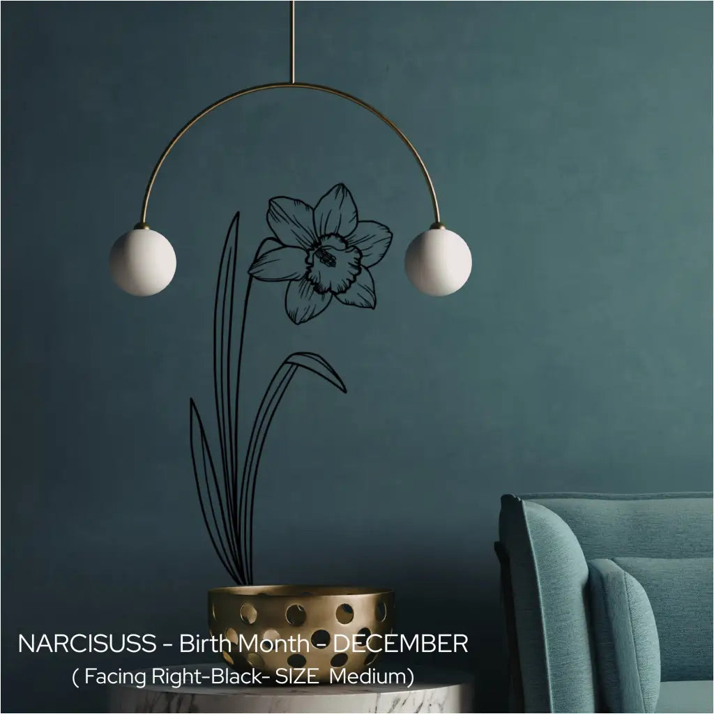 A black Narcissus birth flower wall etching applied vertically behind a modern mobile light fixture on a dark teal wall.