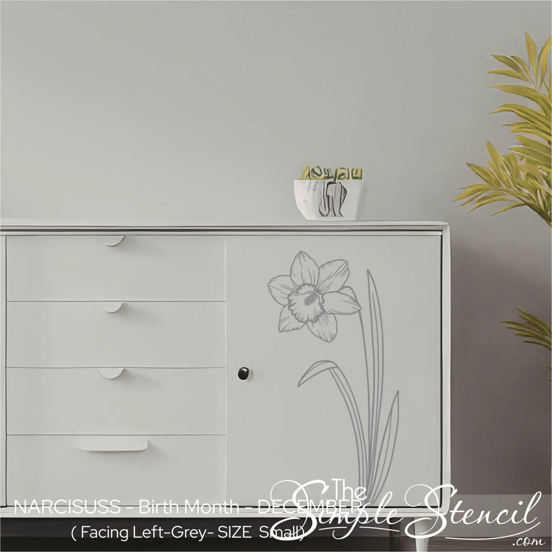 A small grey Narcissus botanical graphic applied to the door of a white minimalist credenza for a sophisticated furniture accent.
