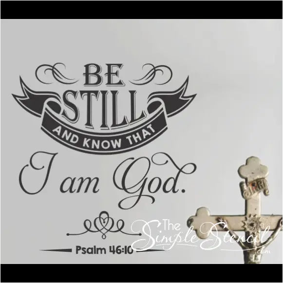 "Be still and know that I am God" wall decal with elegant flourishes displayed in a home living room.